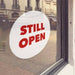 White window cling with red "Still open" lettering - FoodSignPros